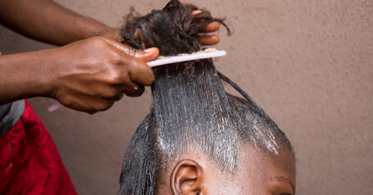 a woman receives hair relaxer treatment | Roberts Wilson, P.A.